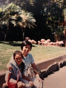 Photo of blogger and her mother in front of flamingos when blogger was a child