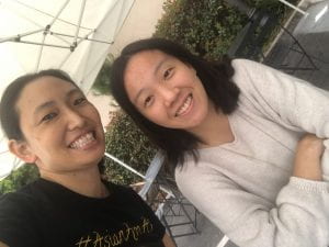 Selfie of the author (Asian American woman in Black t-shirt with #AsianAmAF) and friend (Asian American woman in an off-white sweater) 