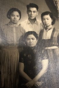 A black and white photograph of 2 young Taiwanese women with their mother and a young Taiwanese man
