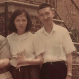 Faded photograph of an Asian woman and man in sepia