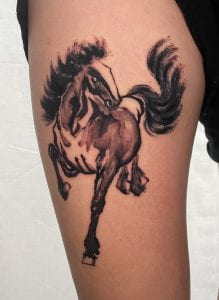 Photograph of brush painted horse tattoo