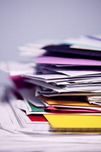 Stack of papers and multicolored files
