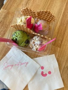 Picture of a flight of ice cream with napkins that have a smiley face and the words Sorry not Sorry in cursive.